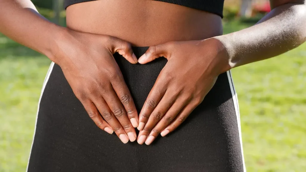 A woman with her hands on her stomach