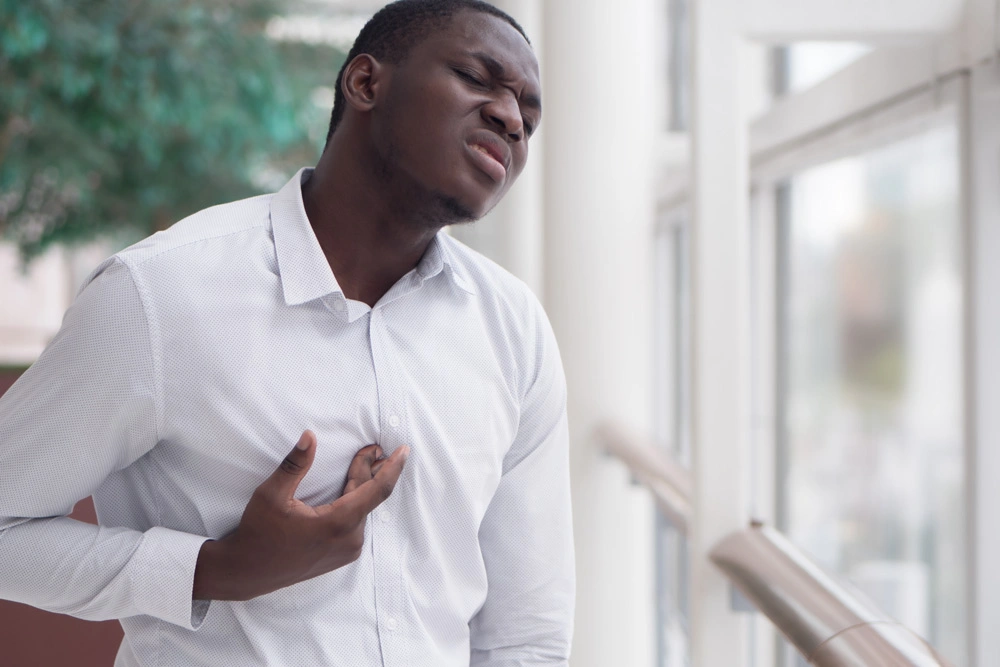 African man suffering from acid reflux or GERD