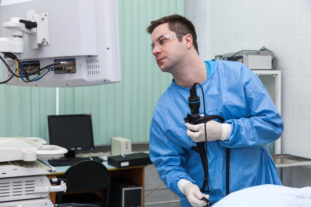 Doctor man in the monitor looks at the results of the colonoscopy.