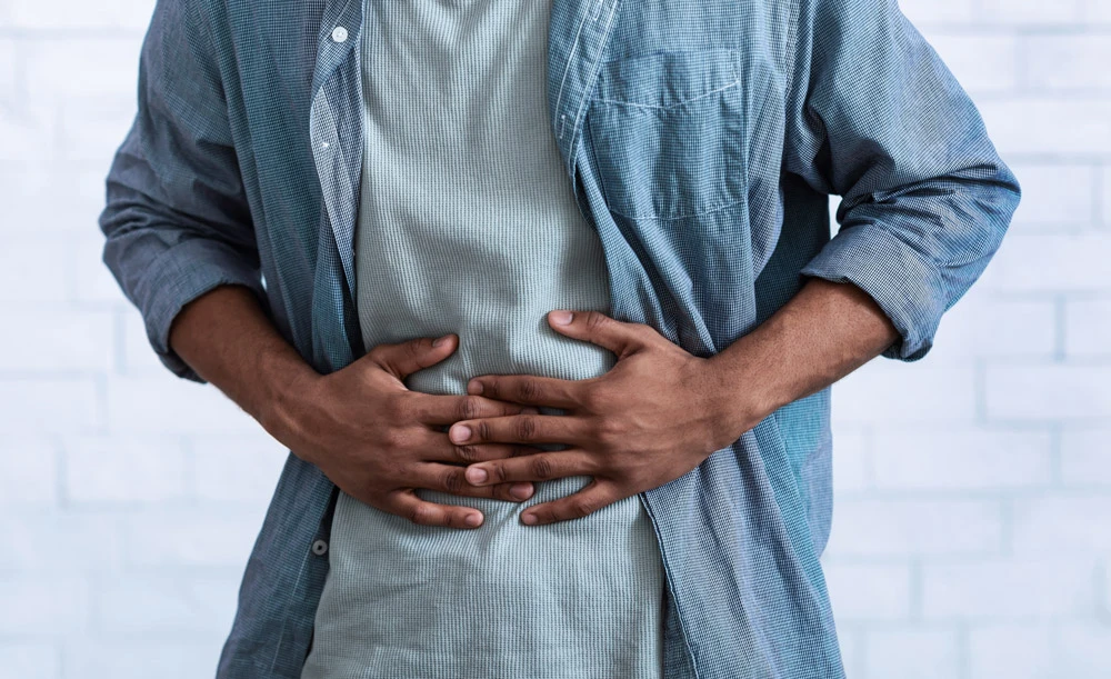 African Man Suffering From Stomach Inflammation.