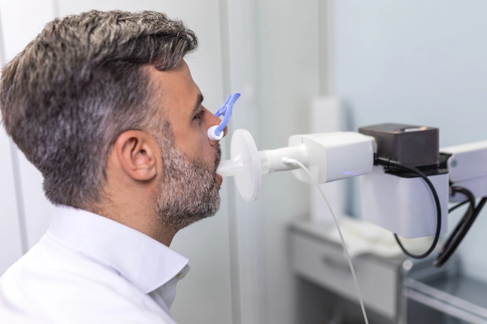 Man testing breathing function by spirometry.