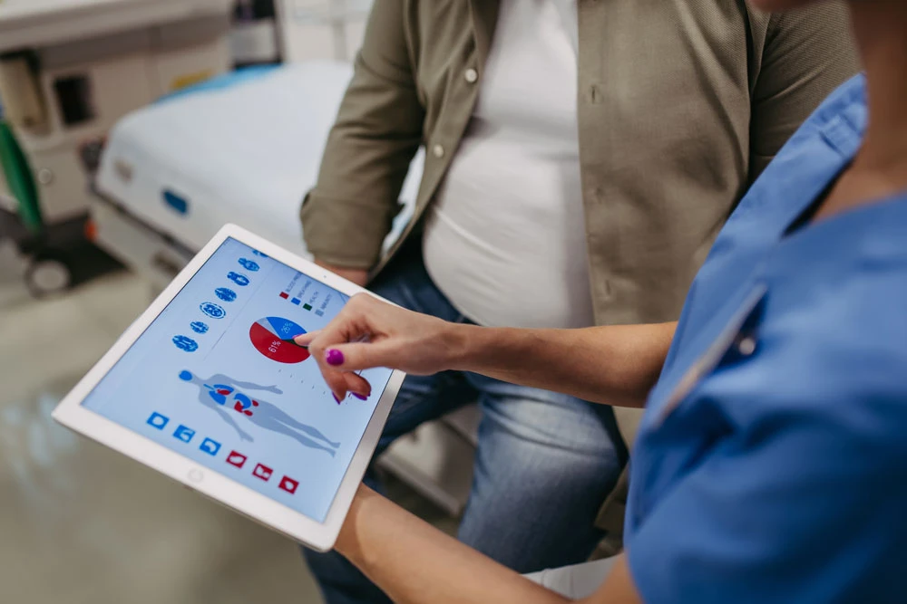 Close up of female doctor consulting with overweight patient,