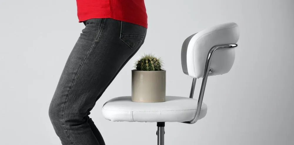 Man sitting like on the cactus in chair