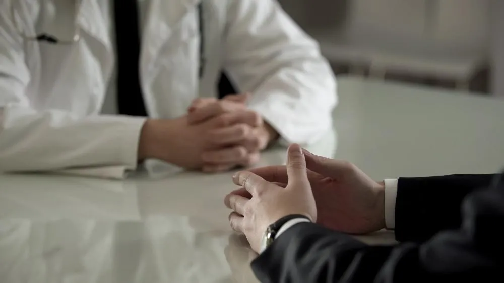 Hands View of Doctor Discussing to Patient