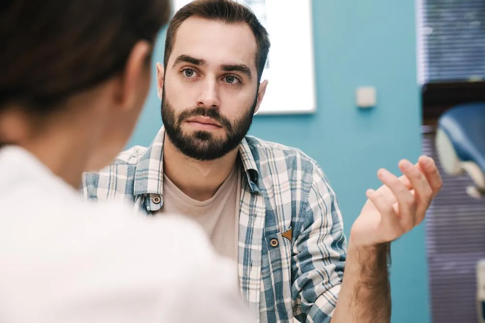 Male patient talking to male doctor