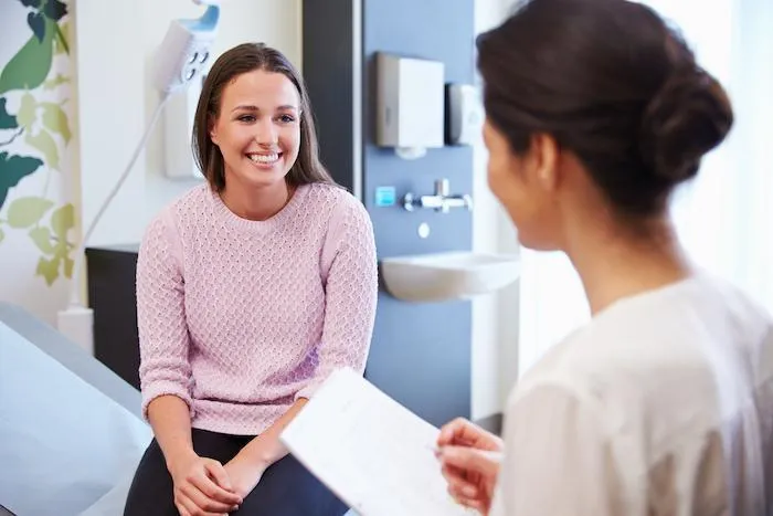 Woman smiling to the physician while discussing