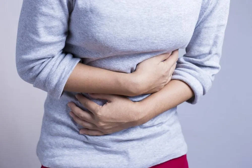 Woman Holding His Stomach in pain