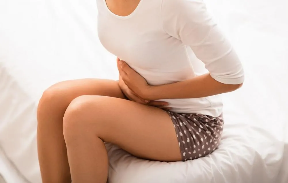 Sitting Woman Holding His Stomach in pain