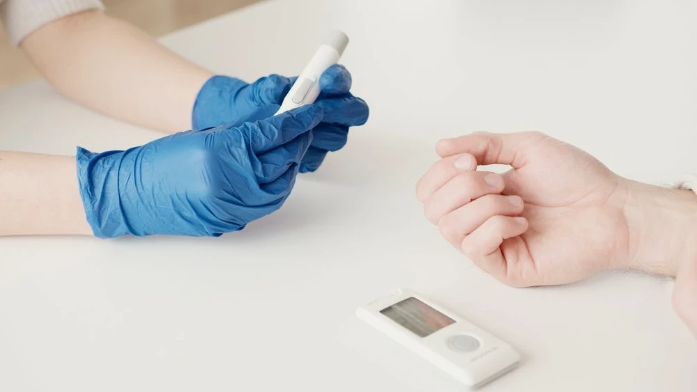 A patient having their blood sugar levels checked