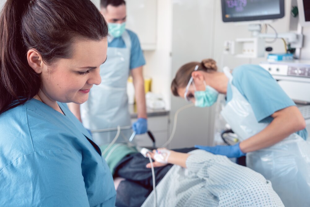 Team of doctors and nurses performing colonoscopy