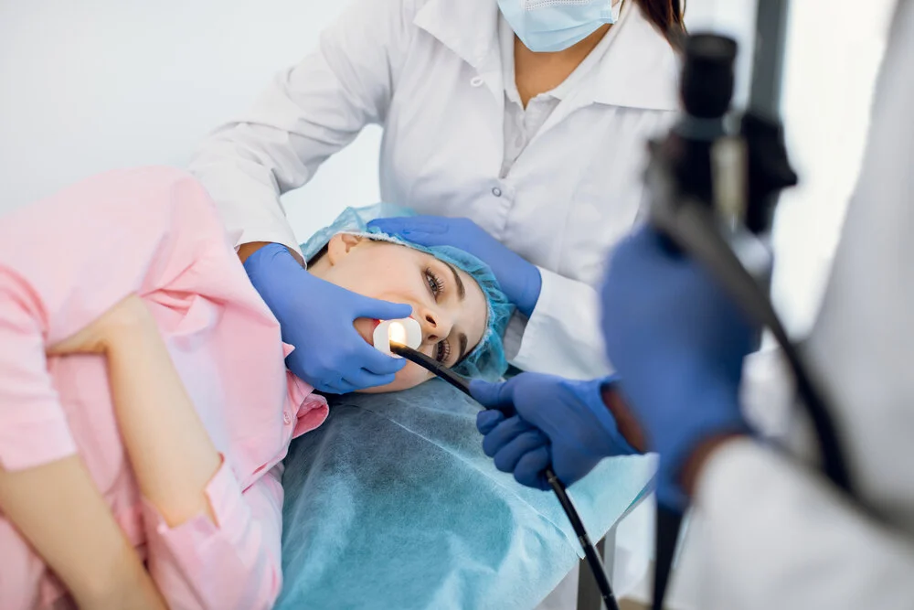 Young woman patient having gastroscopic examination of the stomach and digestive tract