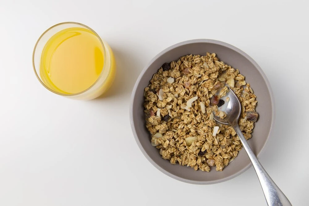 A bowl of oatmeal and a glass of orange juice