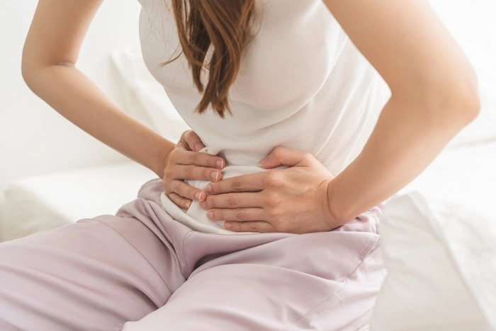 Flatulence ulcer, asian young woman, girl hands in belly, stomach pain from food poisoning, abdominal pain and digestive problem, gastritis or diarrheas.