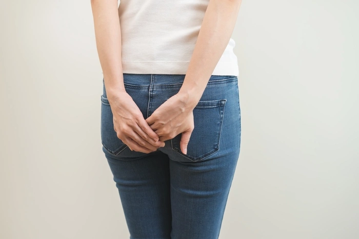 Health care, pain asian young woman suffering from hemorrhoid